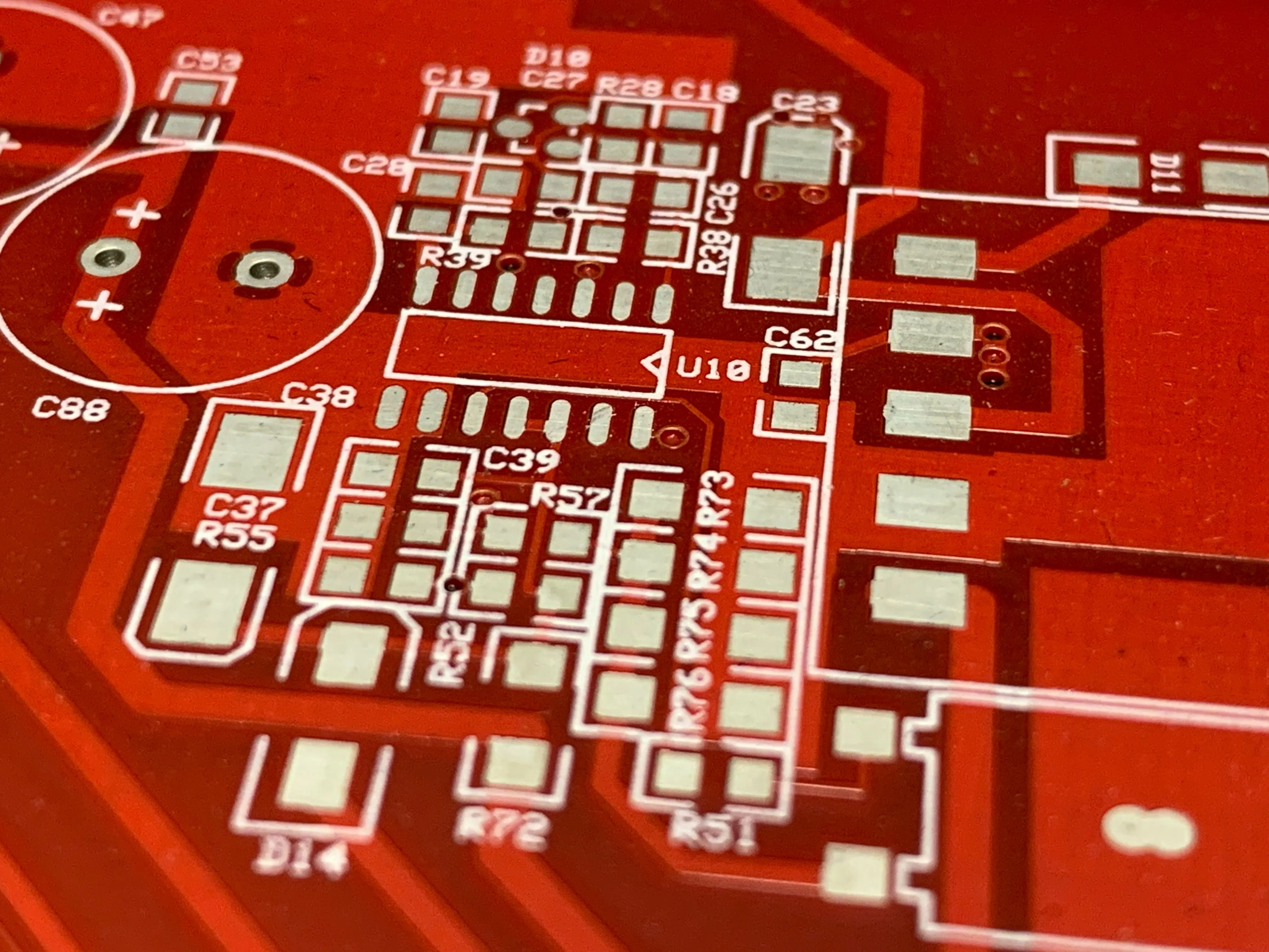 Close-up of a red solder mask PCB with white tin finished pads